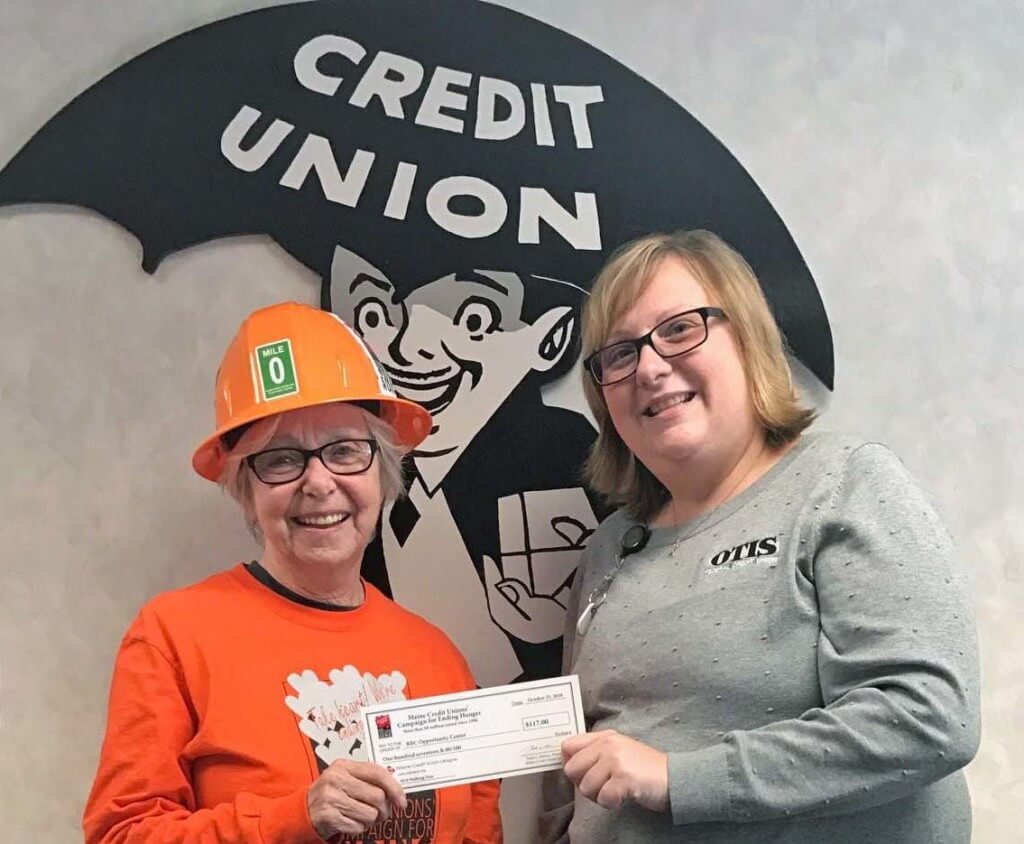 OTIS President/CEO presents Brenda Davis with a check for $117 to benefit local food pantry