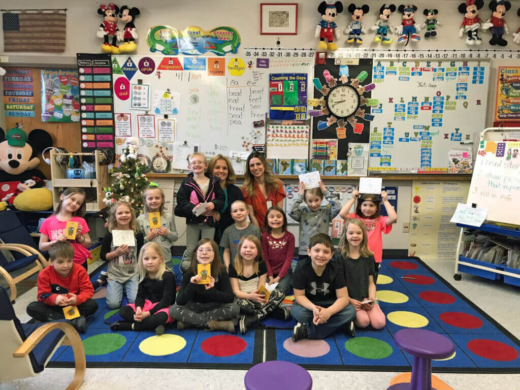 Marketing and Communications Director Sarah hayes is pictured with Mrs. Wiles first grade class