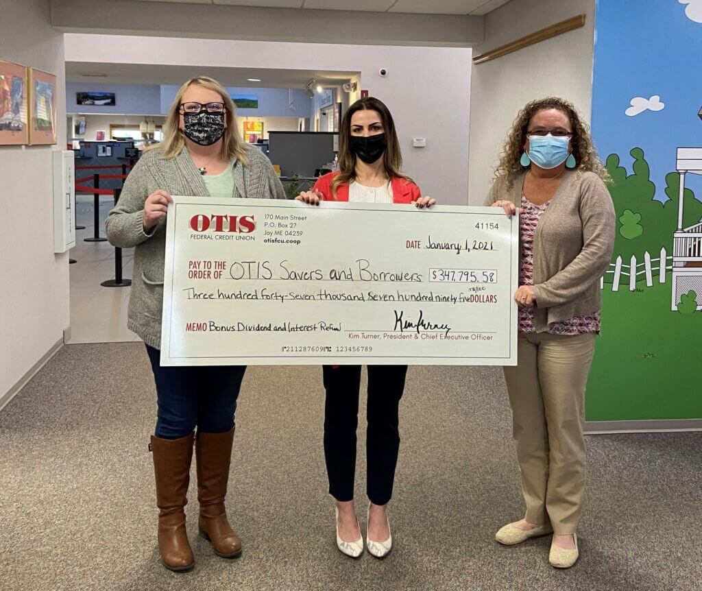 Kim Turner, President/CEO; Sarah Hayes, Director of Marketing and Communications; Darice Dubreuil, Vice President hold OTIS FCU's Bonus Dividend and Interest Refund Check