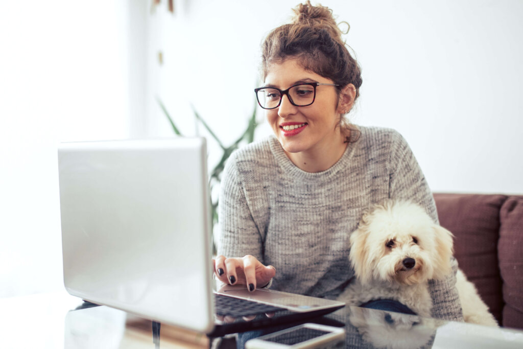 woman with glasses using laptop