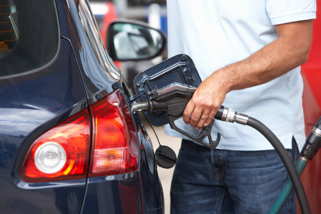 detail of male motorist filling car at petrol station