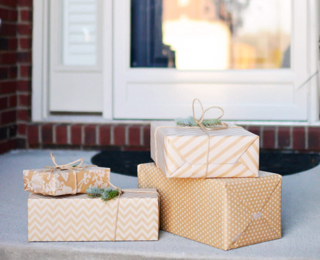 Four tan wrapped gifts on doorstep.