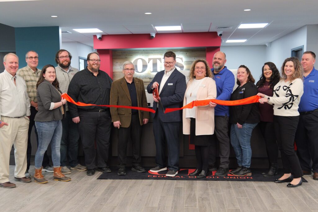 group holding ribbon for ribbon cutting ceremony